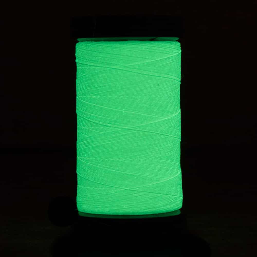 Close up of Ahrora AR03 40wt Glow in the Dark thread spool