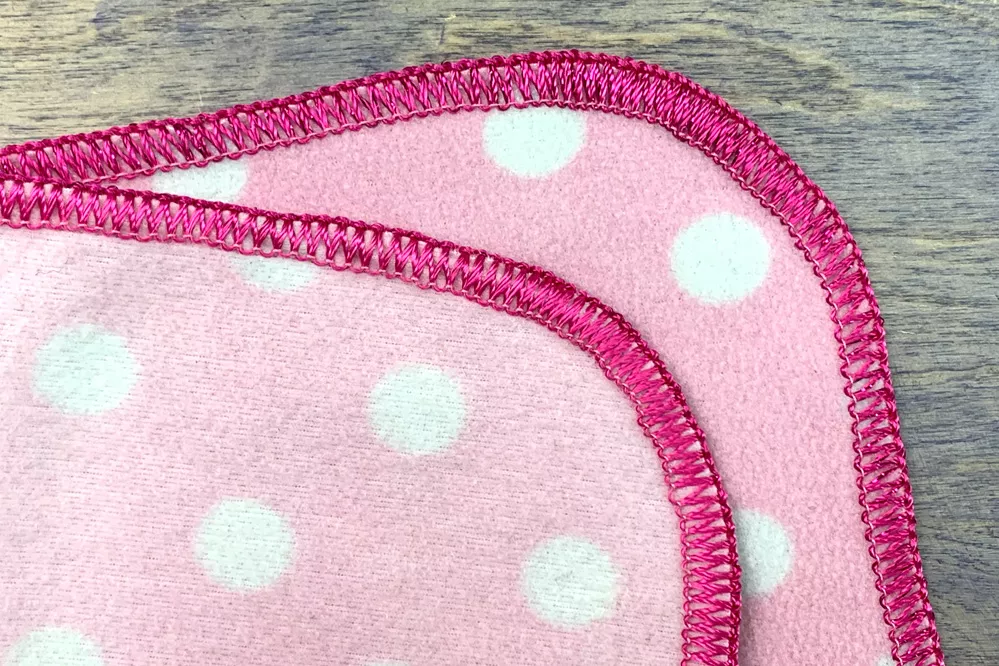 Use Dazzle™ in the upper loopers of your serger to finish any quilt or project with a simple but beautiful edge.