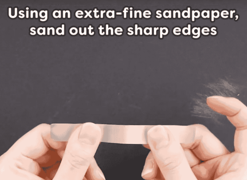 A hand holding a card Description automatically generated
