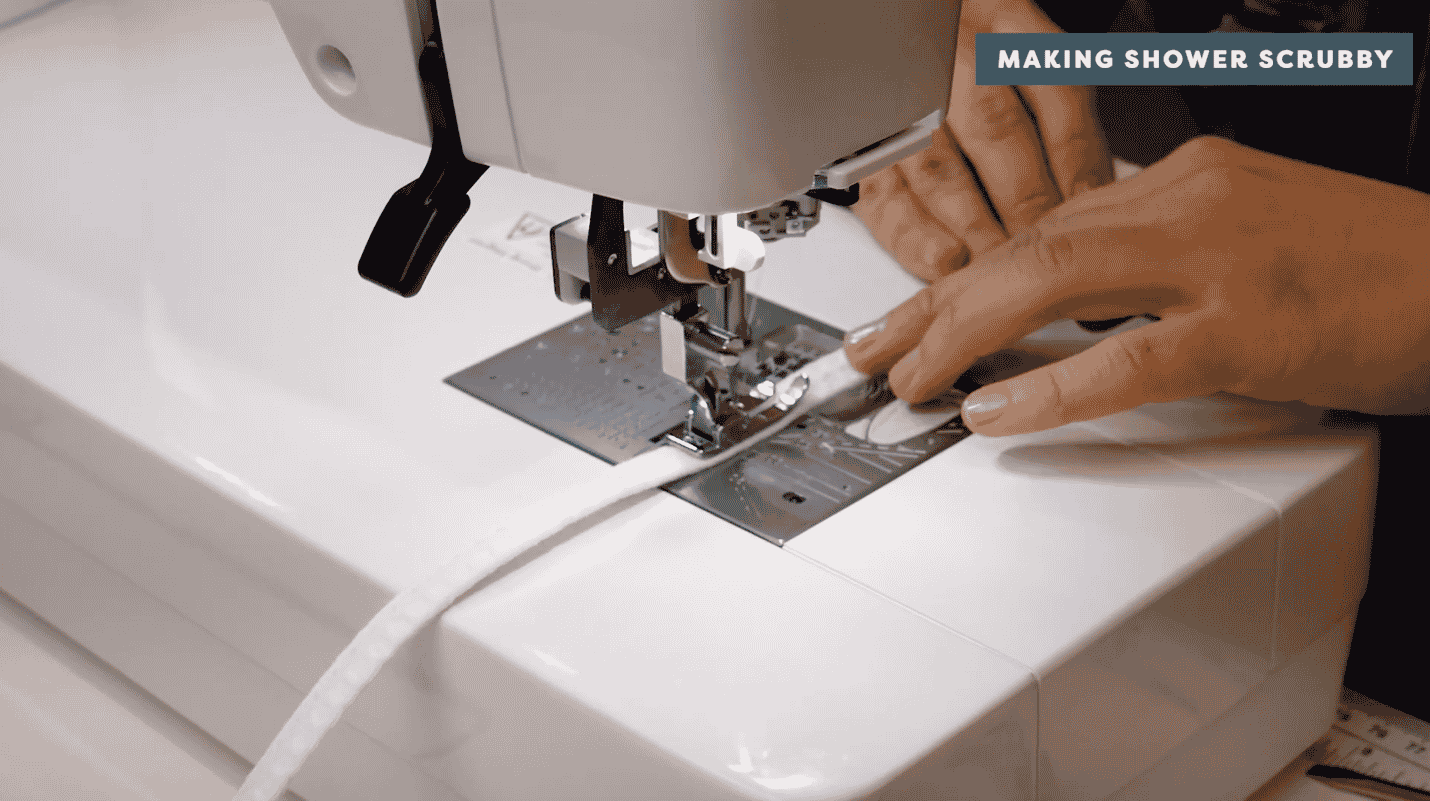 A picture containing sewing machine, appliance, indoor, person Description automatically generated